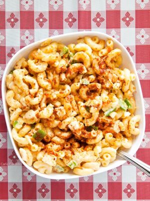 Amish Macaroni Salad in white bowl on red checkered background