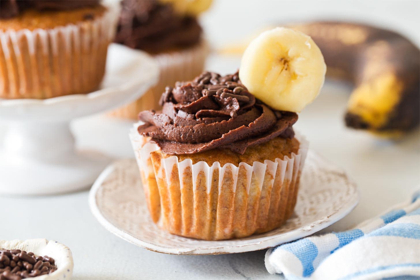 Banana Cupcakes with buttercream frosting on a plate