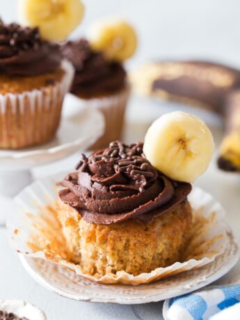 Unwrapped banana cupcake with chocolate frosting