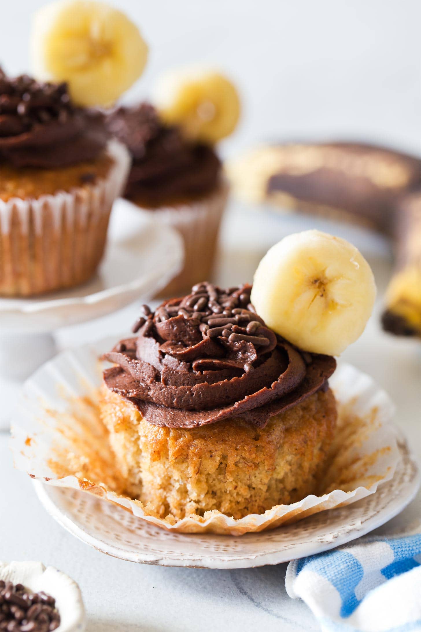 Unwrapped banana cupcake with chocolate frosting