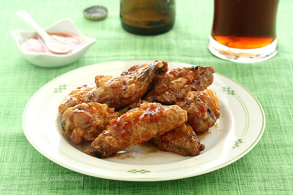 Plate of sweet chili wings on green tablecloth