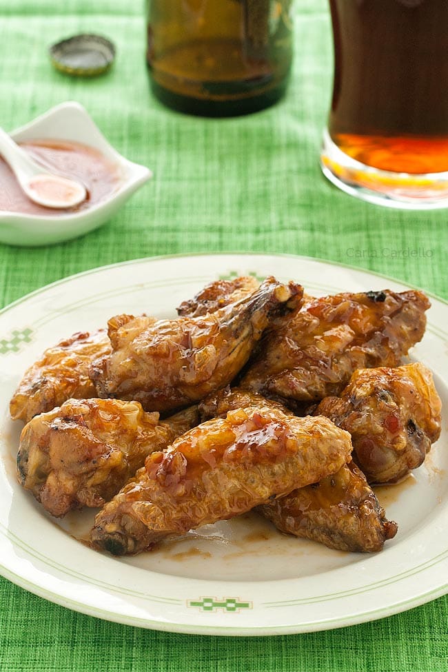 Plate of sweet chili wings on green tablecloth