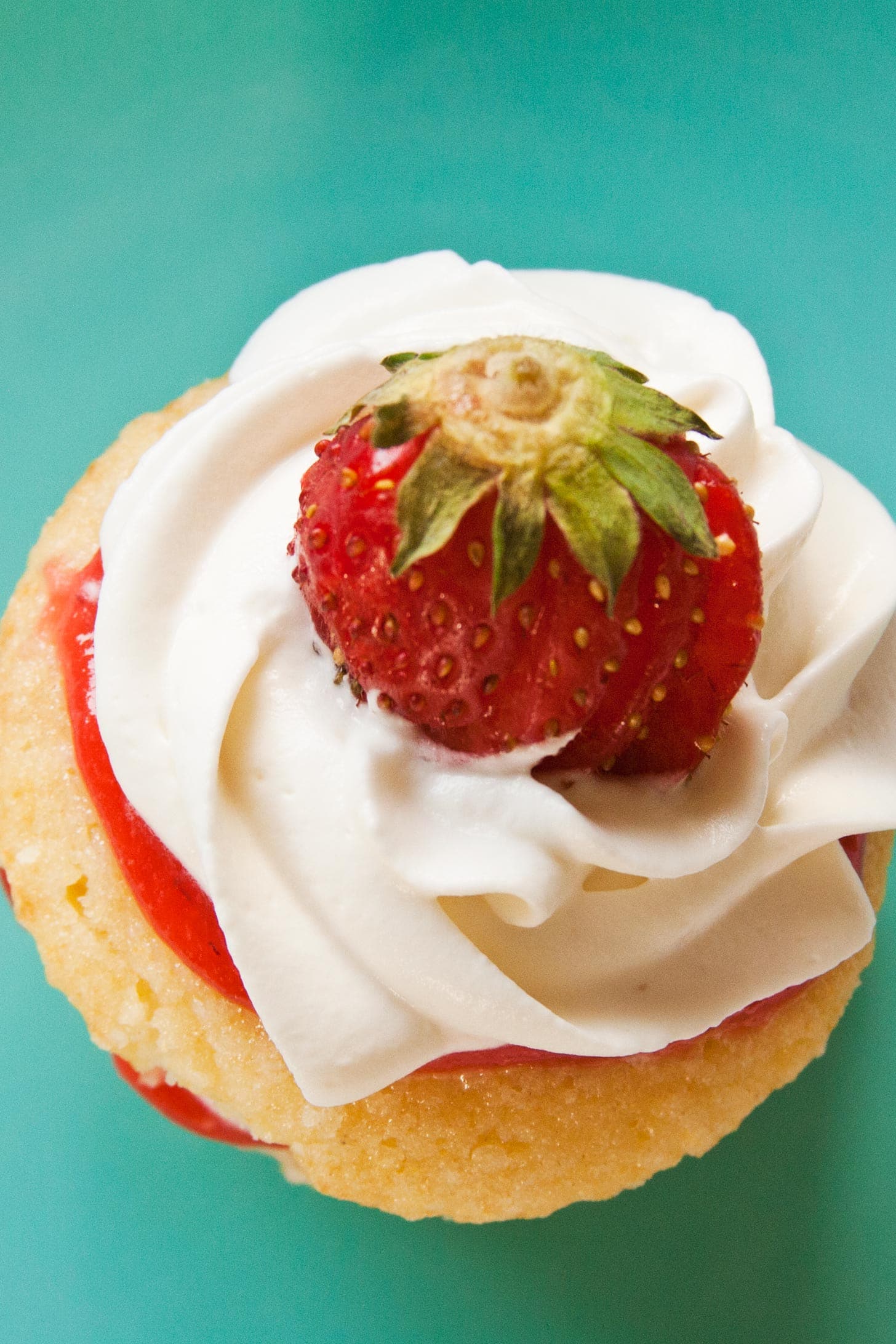 Overhead view of strawberry shortcake cupcakes with whipped cream