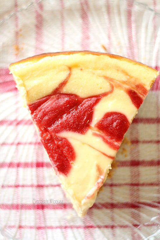 Slice of strawberry swirl cheesecake on a plate