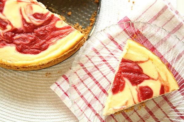 Slice of strawberry swirl cheesecake on a plate