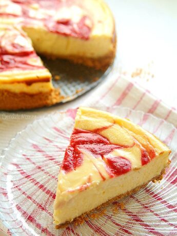 A slice of strawberry swirl cheesecake on a plate