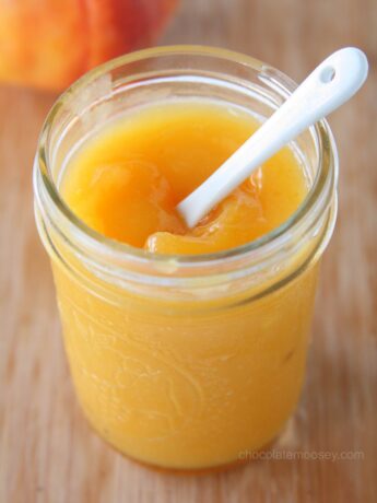 Peach Curd in a jar with white spoon