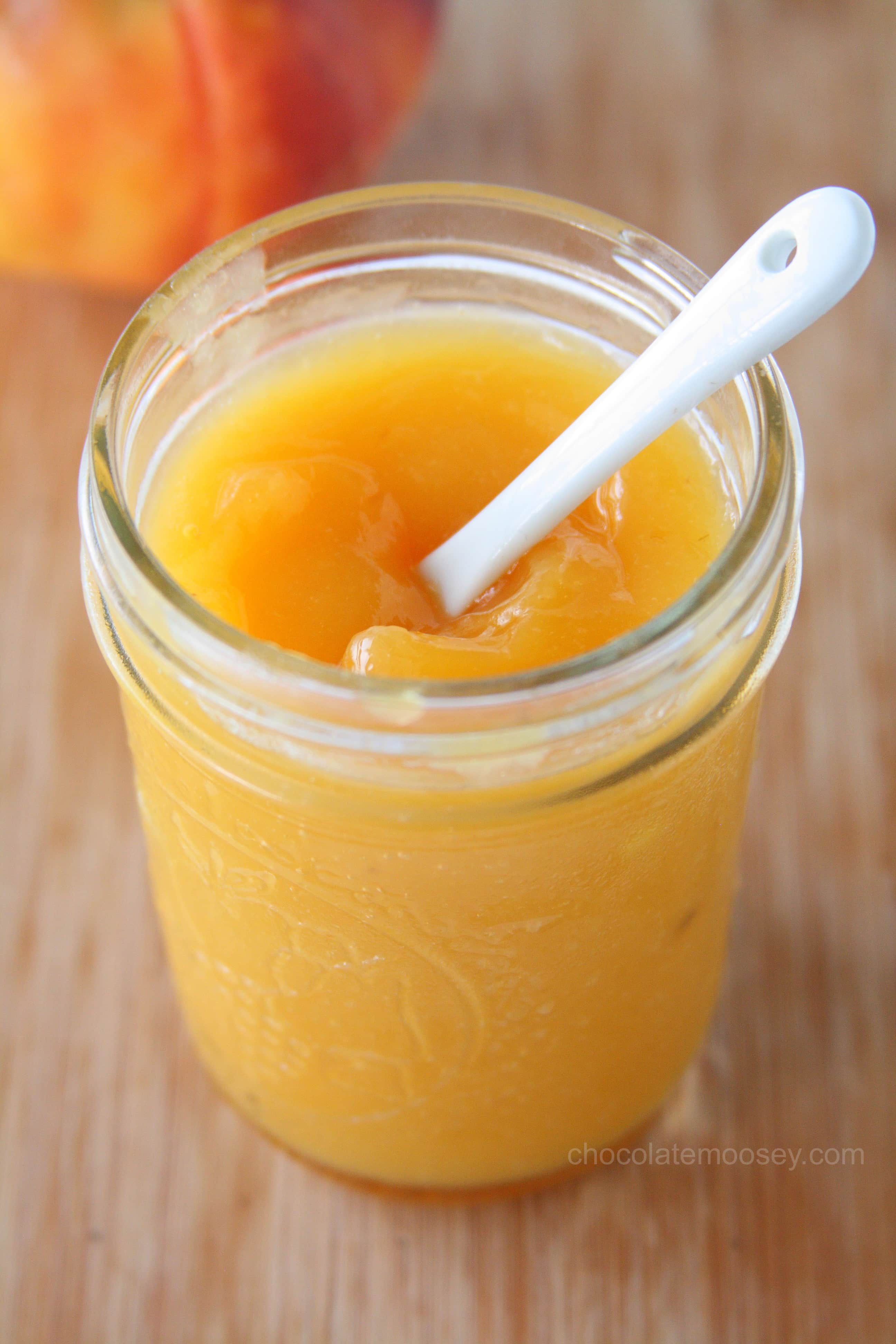 Peach Curd in a jar with white spoon