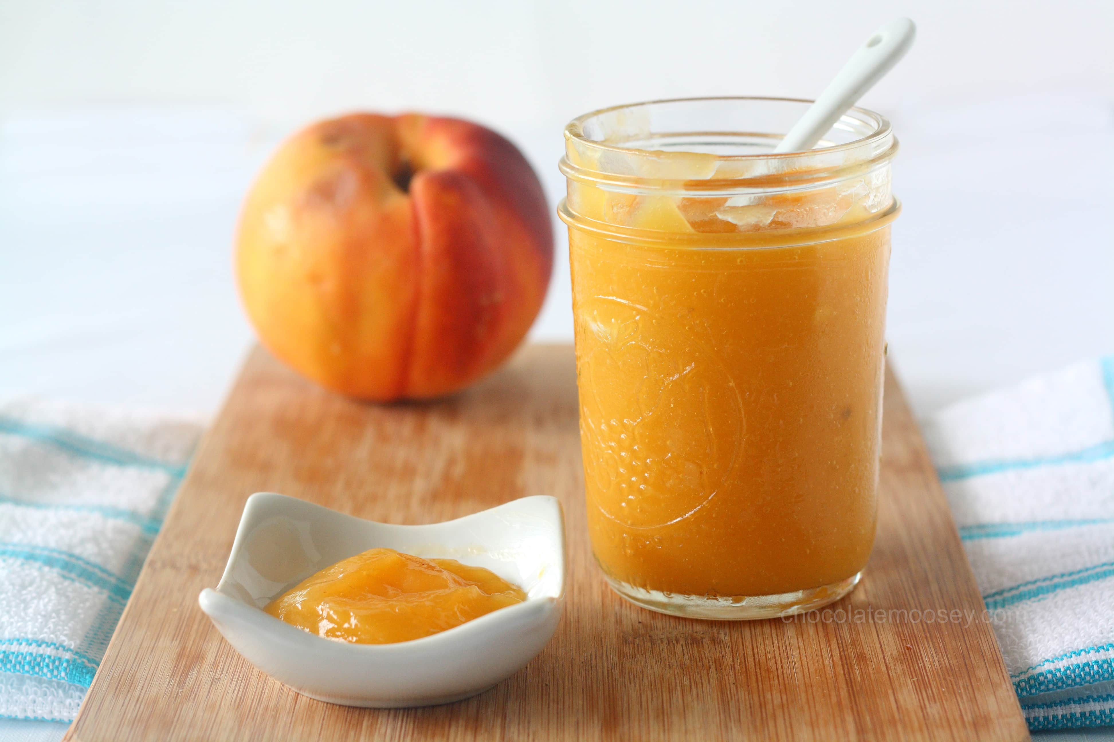 Peach curd in a jar on cutting board