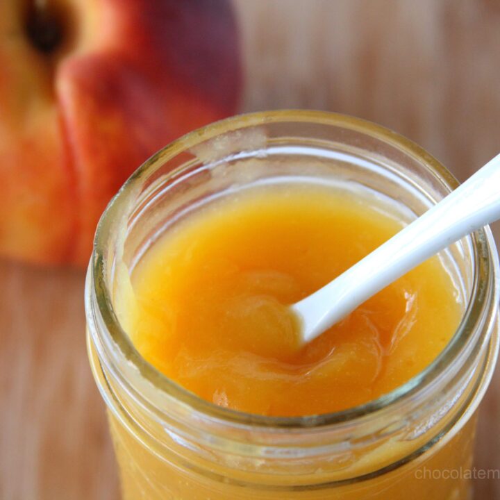 Peach Curd in a jar with white spoon