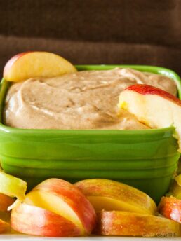 Green bowl filled with caramel apple cheesecake dip