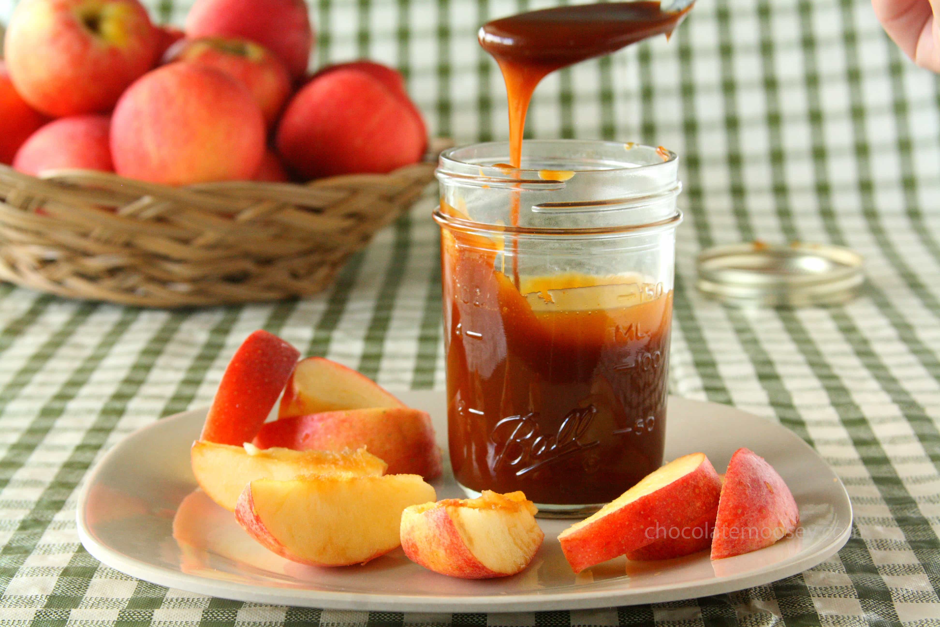 Caramel sauce drizzling off spoon into jar