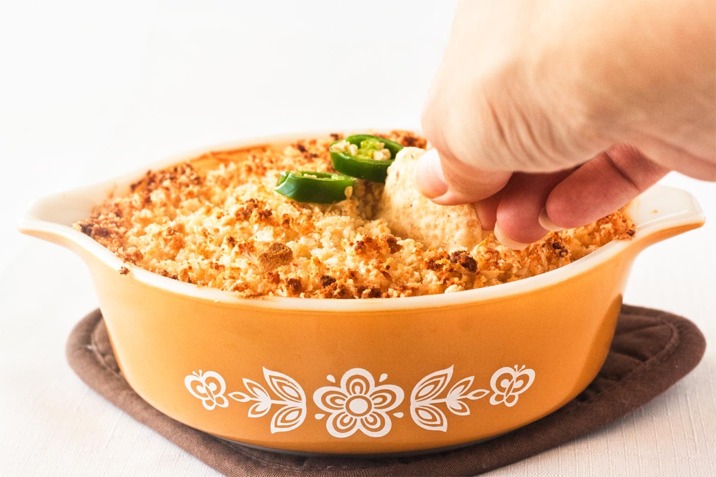 Serving jalapeno popper dip with nachos