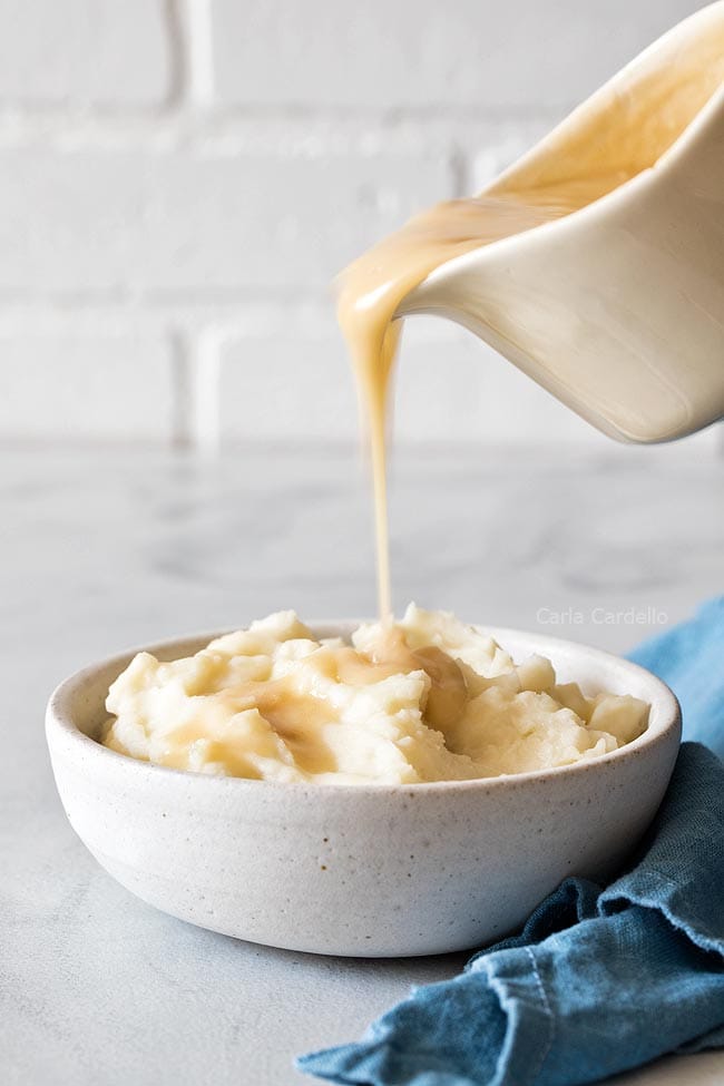 Pouring Gravy Over Mashed Potatoes