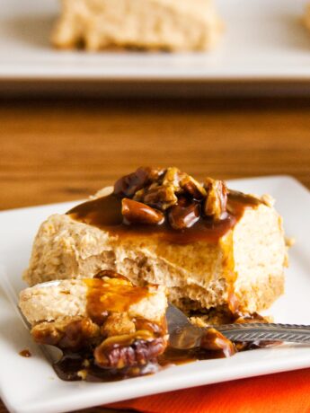 Spoon cutting into no bake pumpkin cheesecake bar
