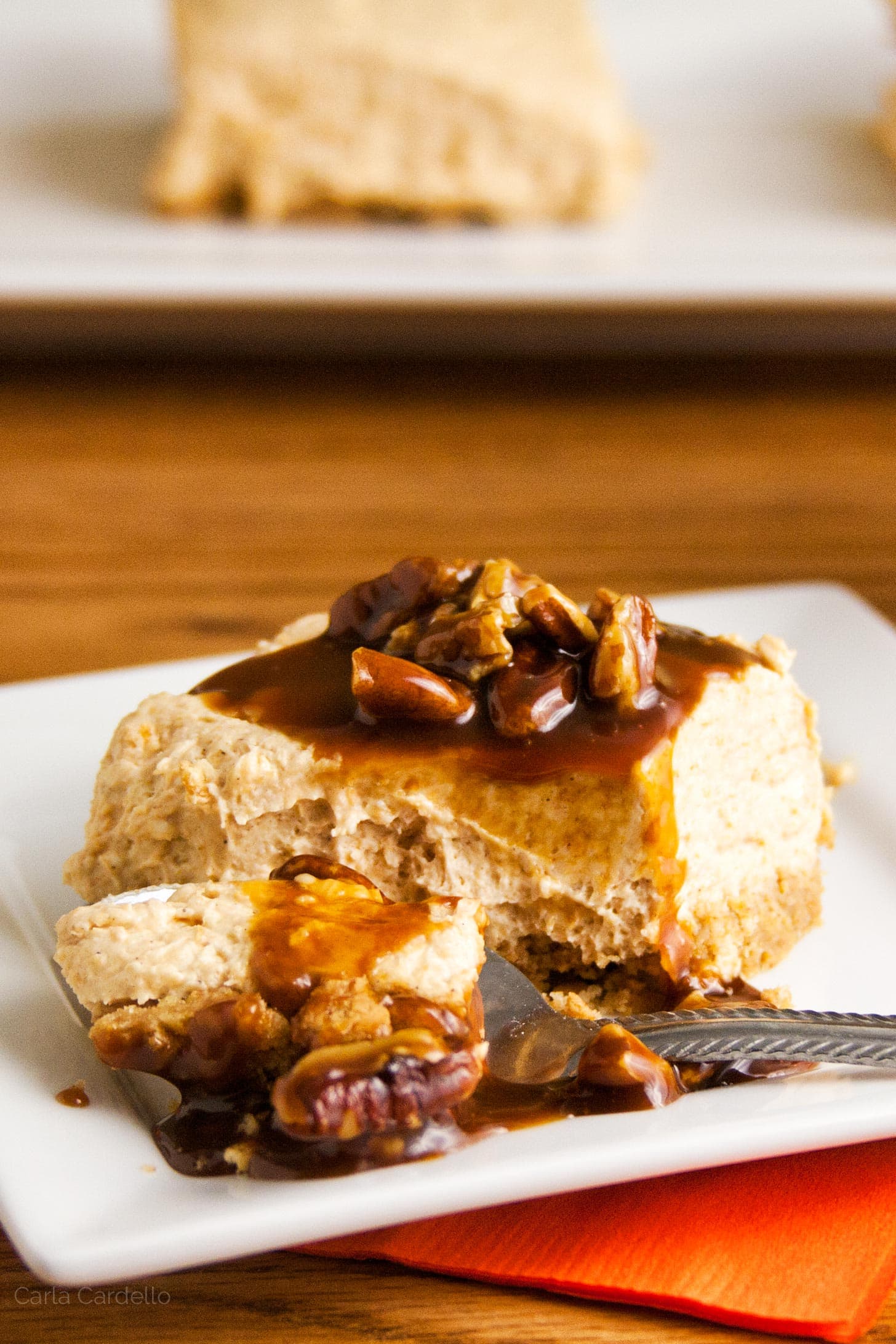 Spoon cutting into no bake pumpkin cheesecake bar