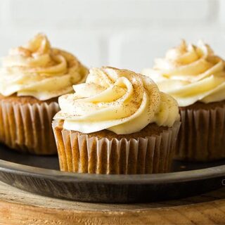 Three pumpkin cupcakes on a plate