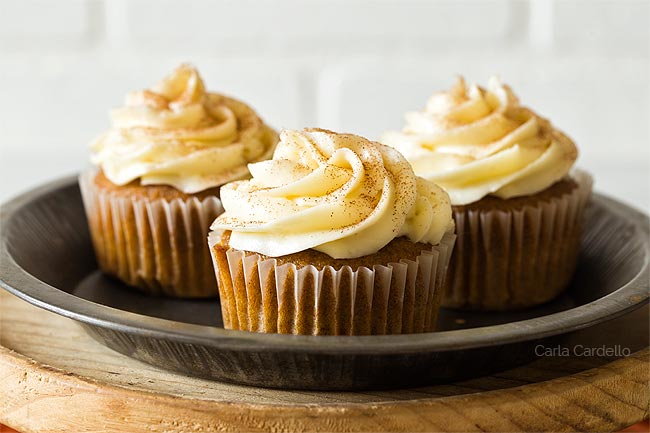 Three pumpkin cupcakes on a plate