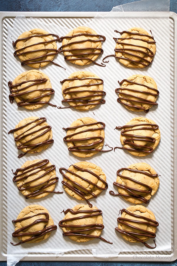 What's better than a single peanut butter cookie? Double Peanut Butter Surprise Cookies stuffed with a peanut butter cup and drizzled with chocolate on top.