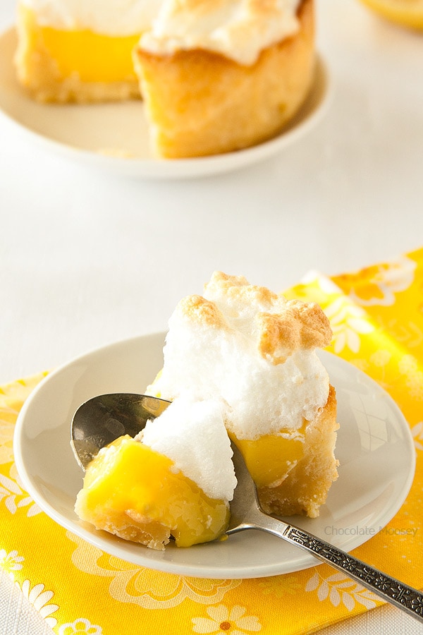 Spoon cutting into lemon meringue mini pie