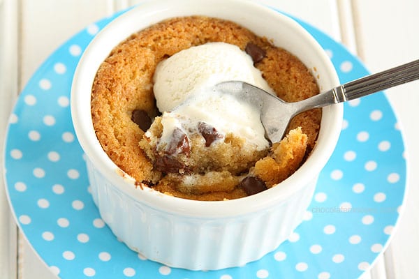 Deep Dish Chocolate Chip Cookie in a white ramekin on a blue plate