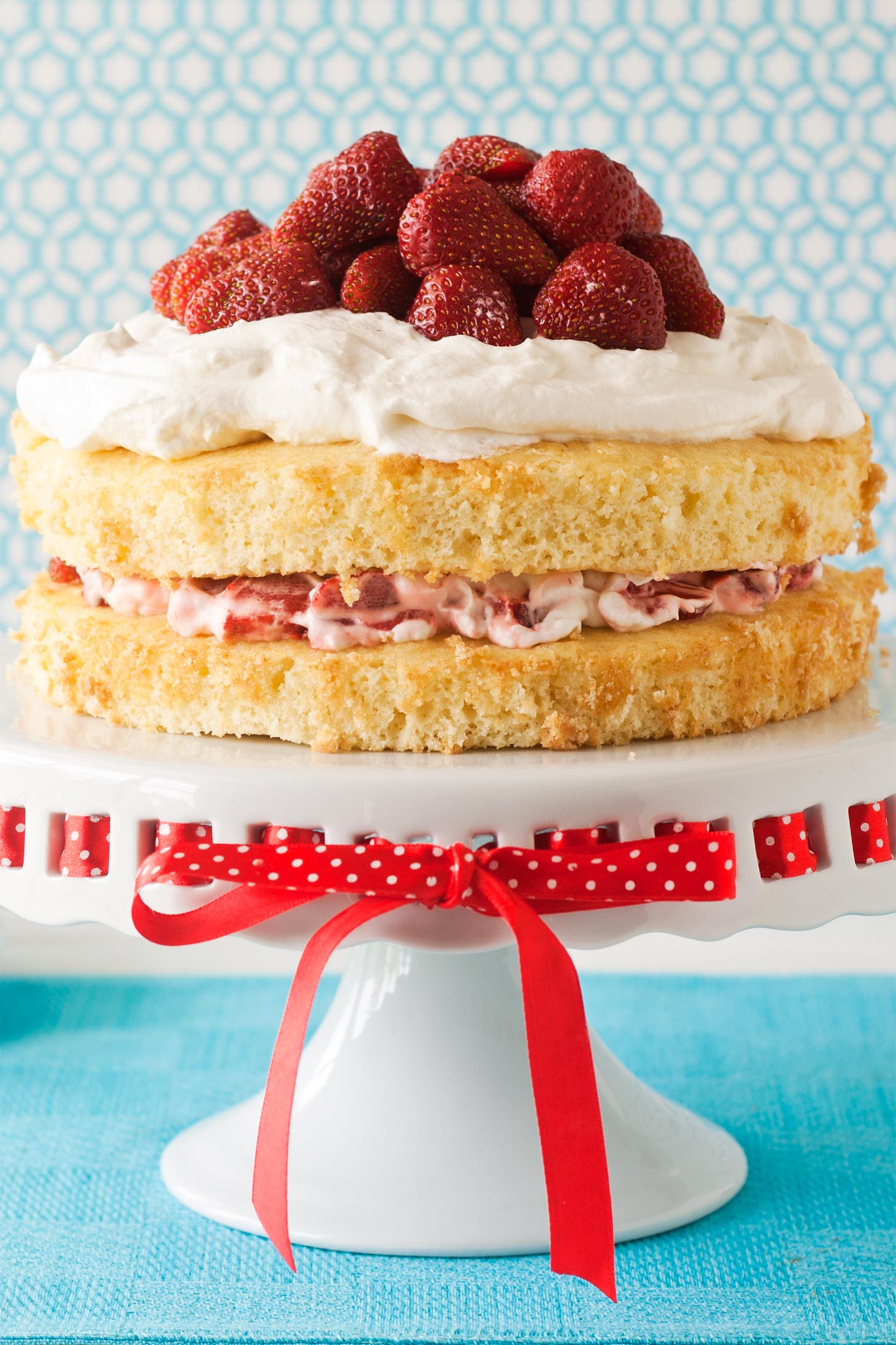 Strawberry Shortcake Cake with sponge cake, whipped cream, and berries