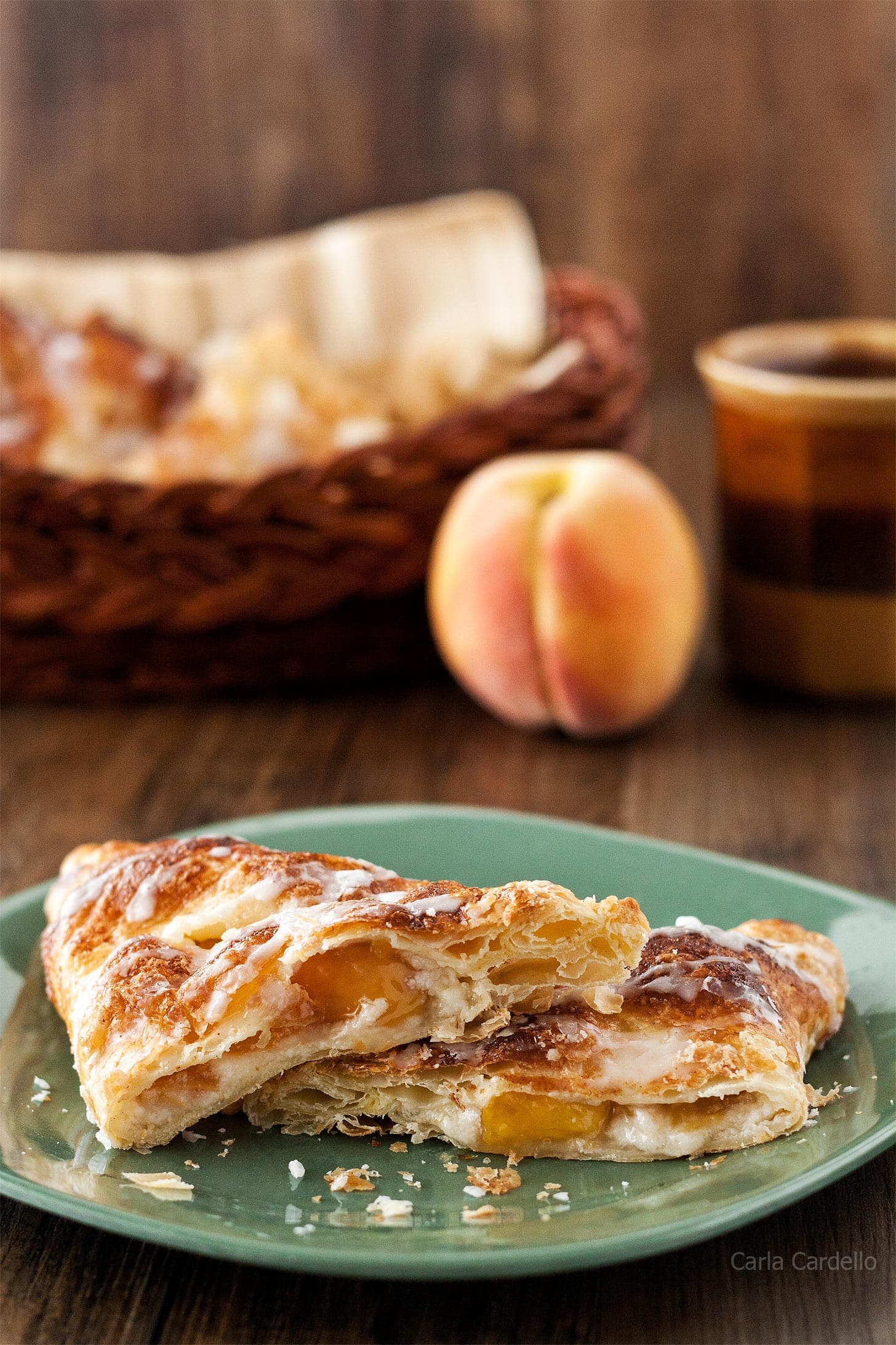 Puff Pastry Peach Turnovers cut in half on a green plate