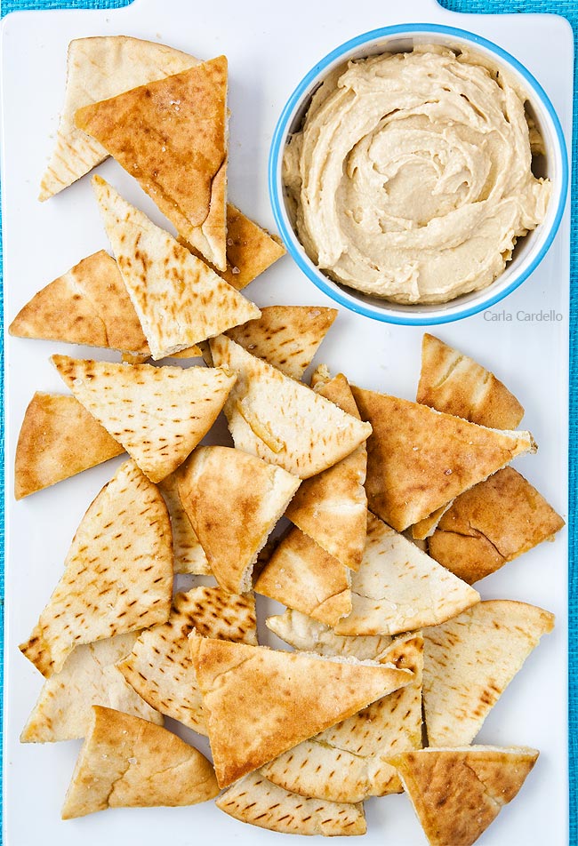 Close up of homemade pita chips on white serving platter