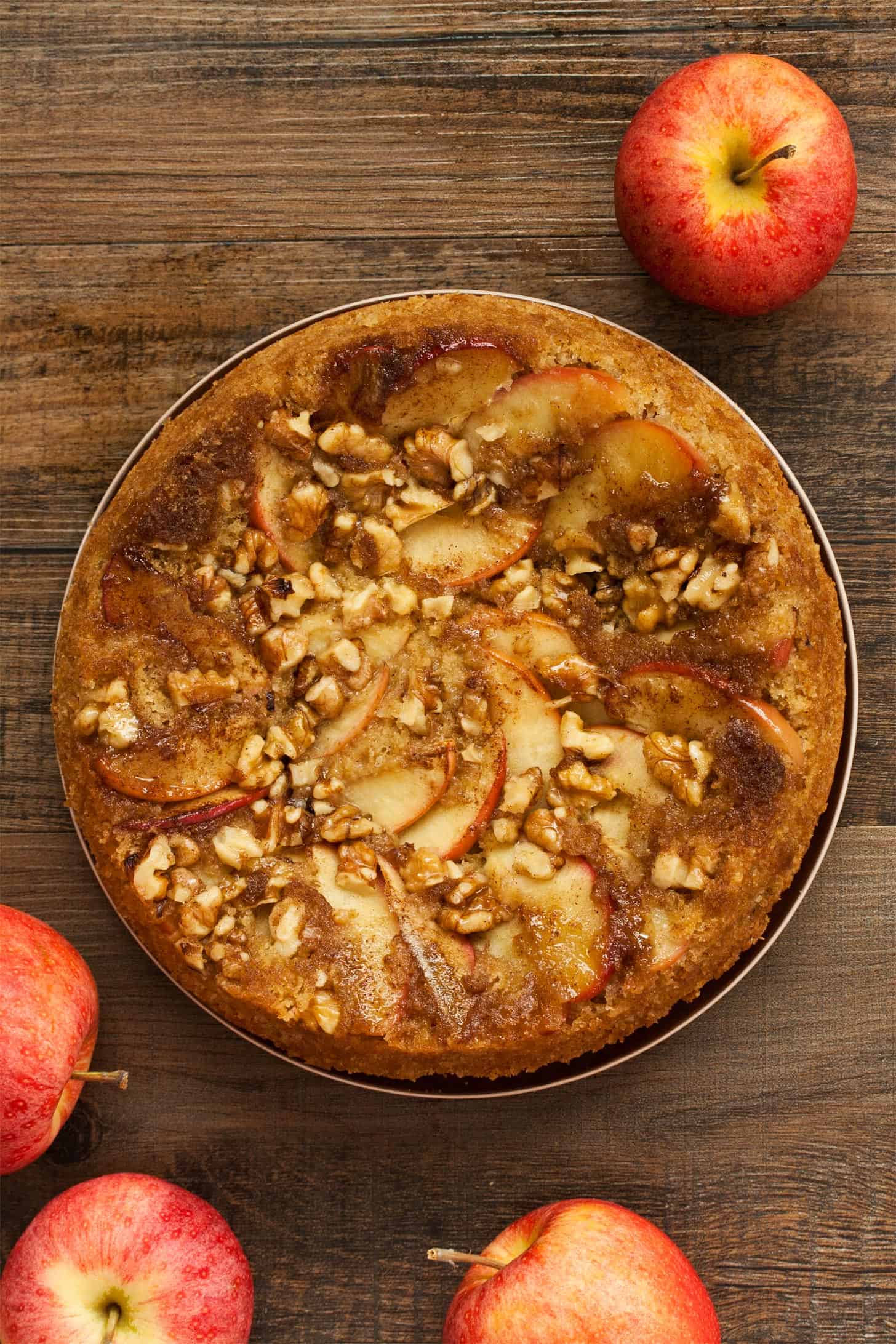 Apple Upside Down Cake with apples on wooden table