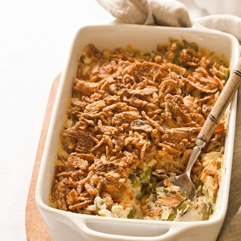 White casserole dish filled with green bean casserole