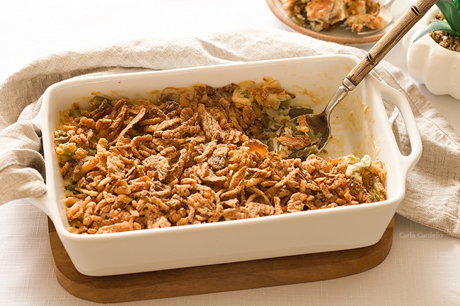 White casserole dish filled with green bean casserole