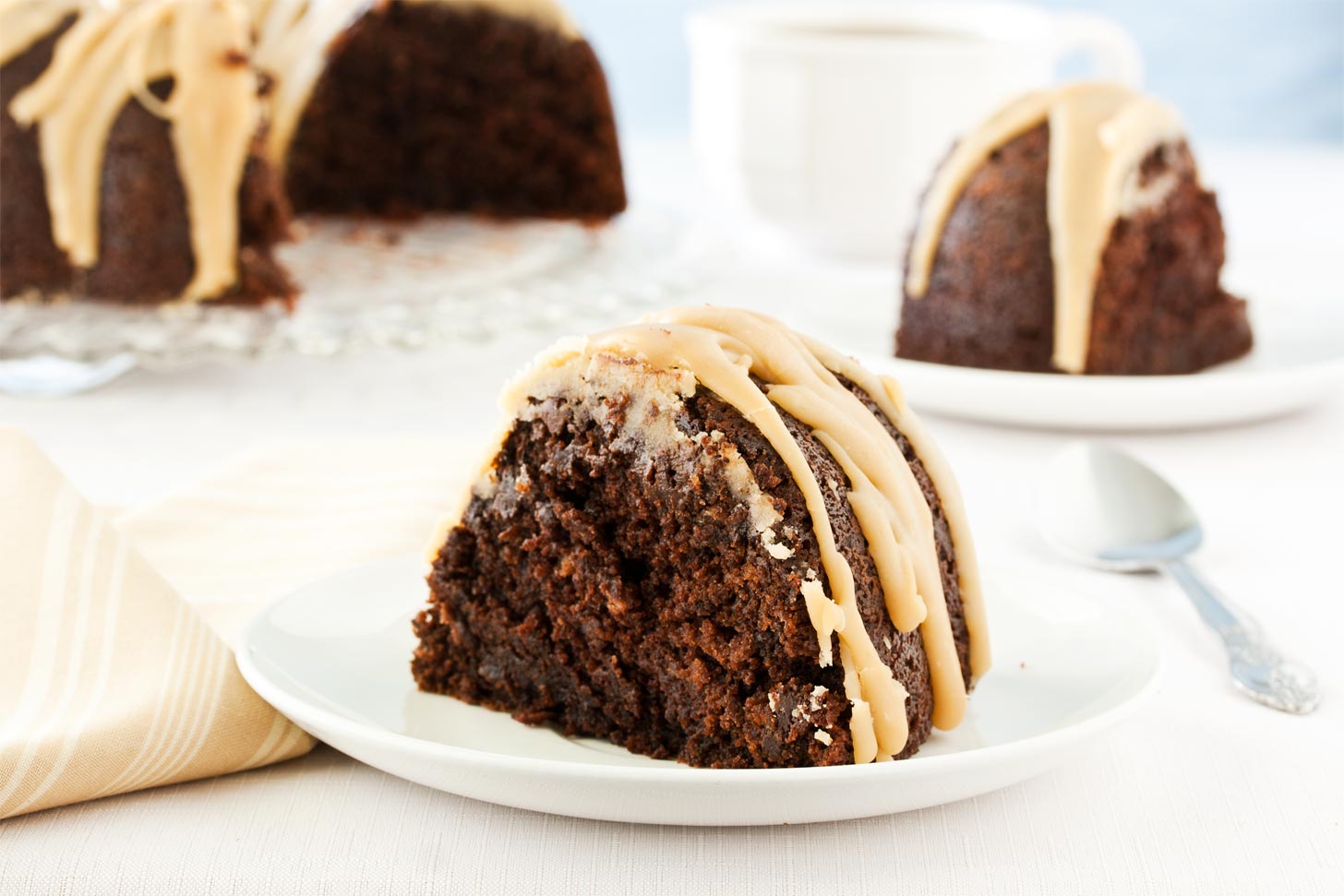 Slice of chocolate bundt cake on white plate