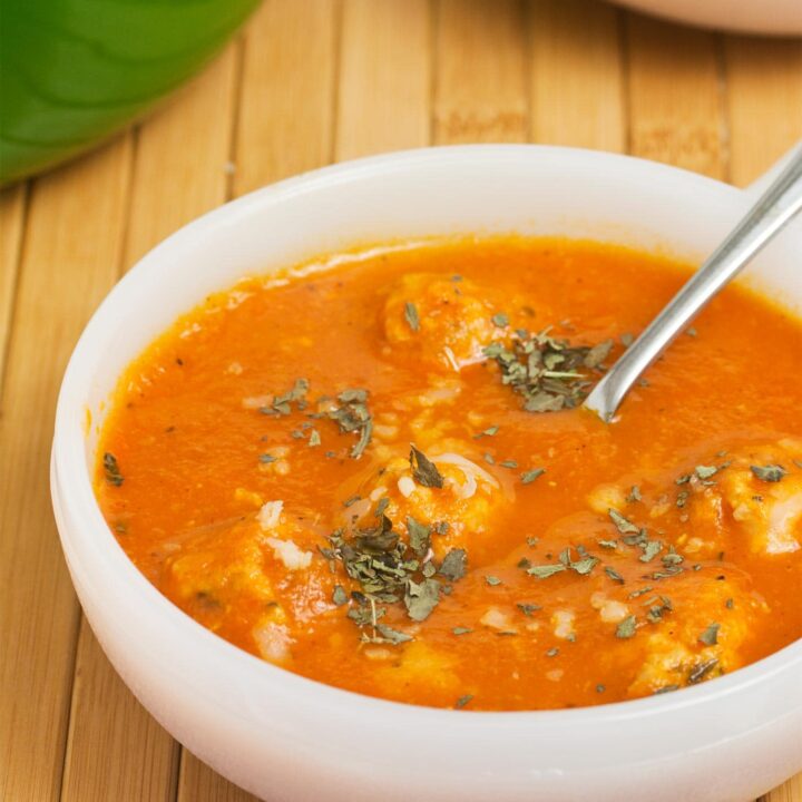 Close up of ground chicken meatballs in tomato soup