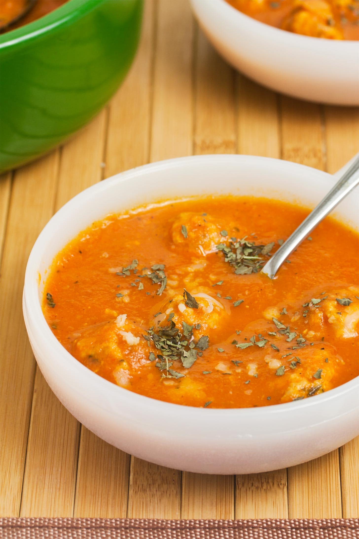 Close up of ground chicken meatballs in tomato soup