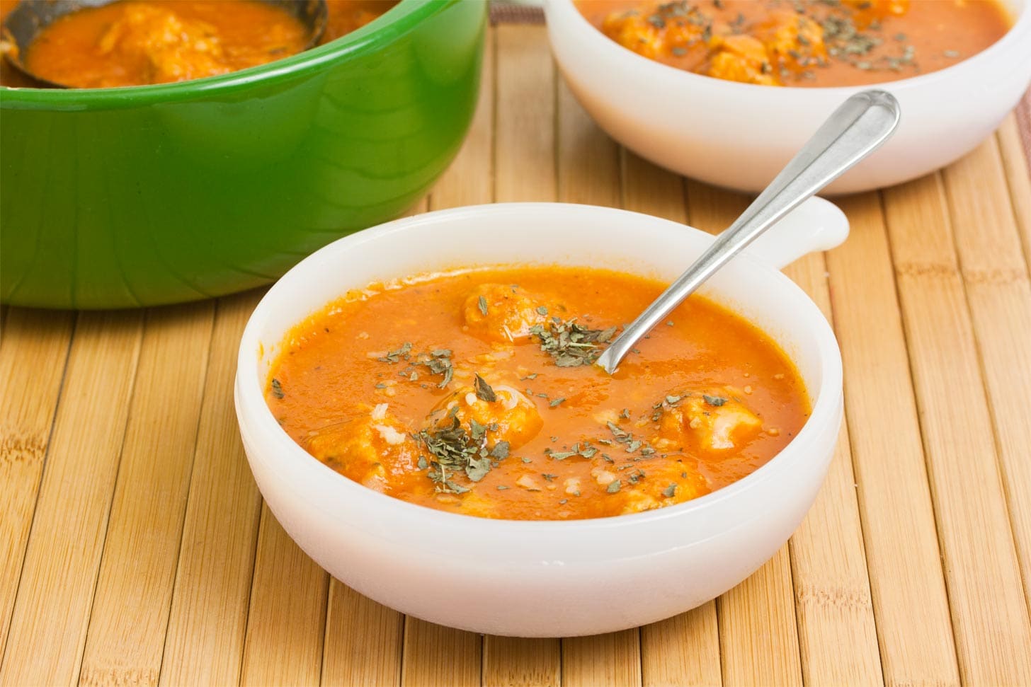 Chicken meatball soup in white bowl