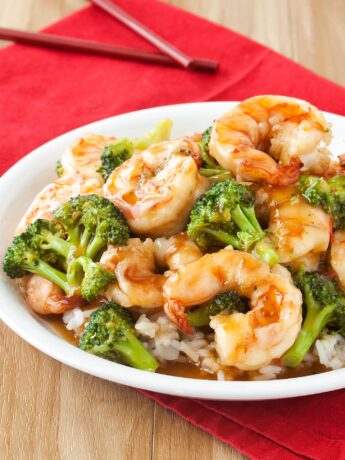 Plate of general tso shrimp with broccoli and rice