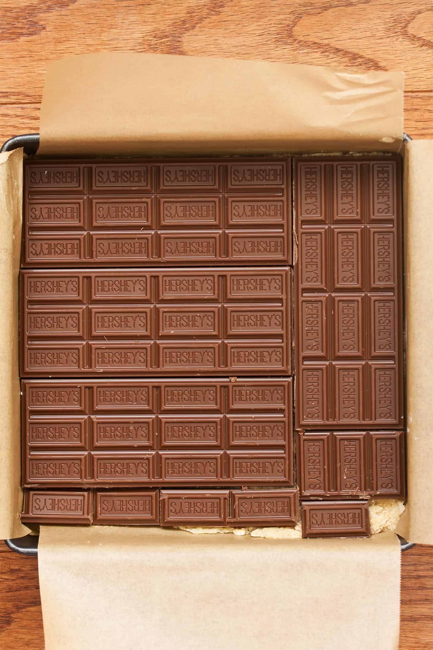 Adding chocolate bars to make smores bars