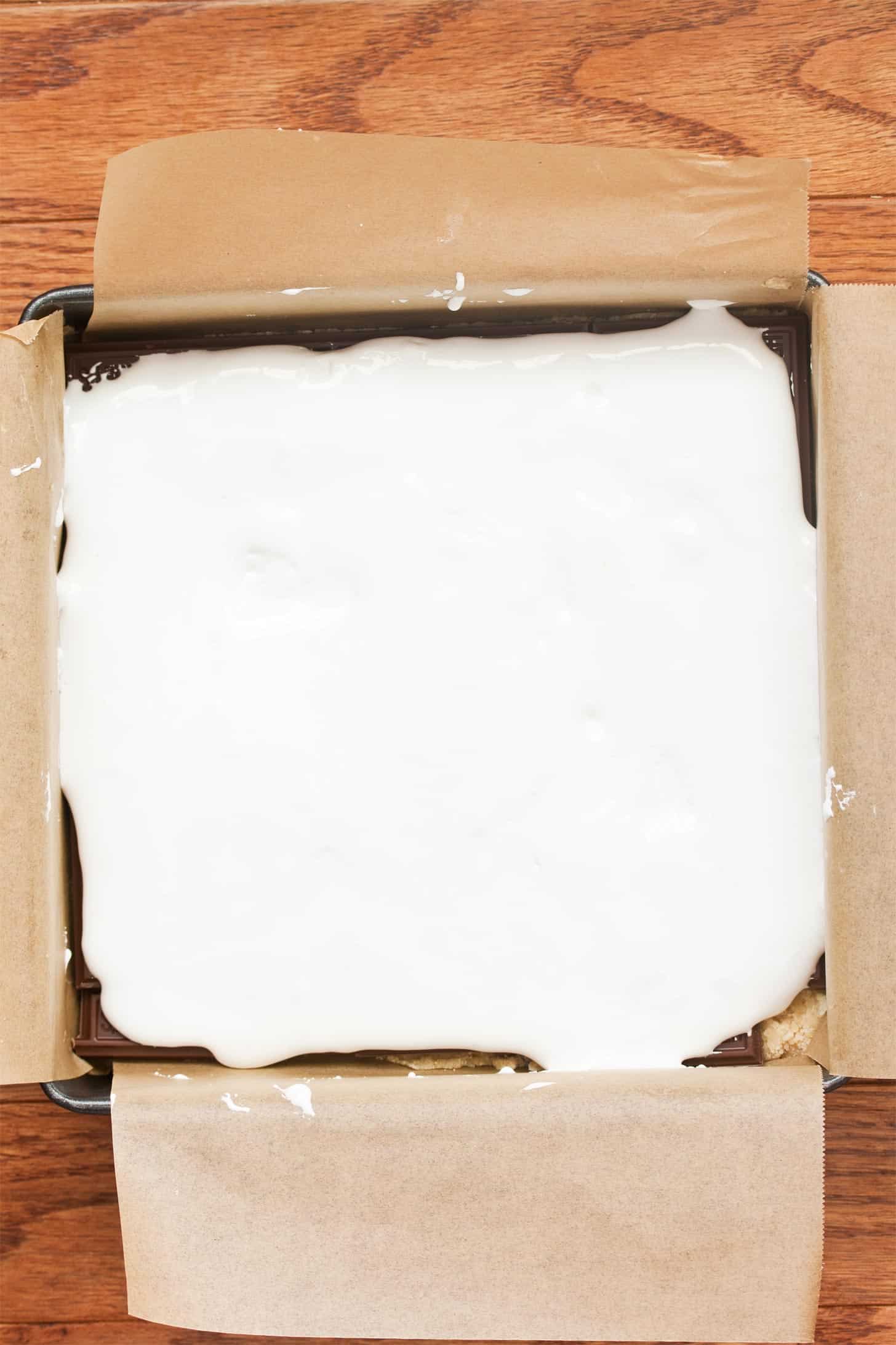 Adding marshmallow fluff to smores bars