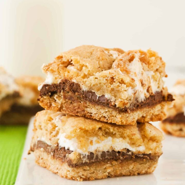 Two Smores Bars stacked on a white cutting board