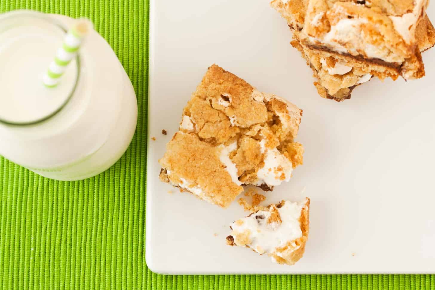 Gooey smores cookie bars on white cutting board
