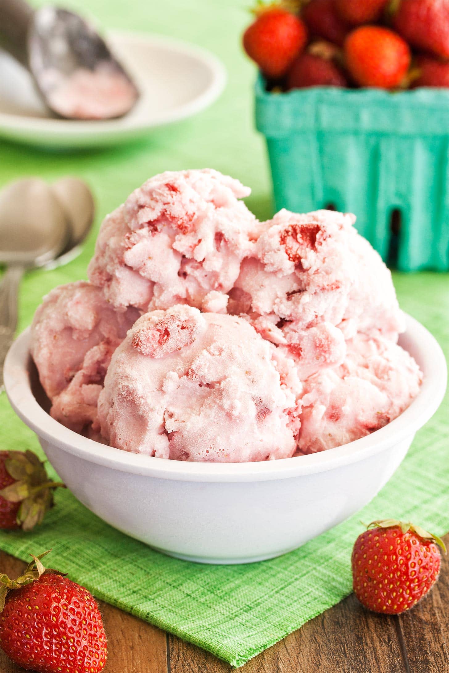 Bowl full of strawberries and cream ice cream scoops