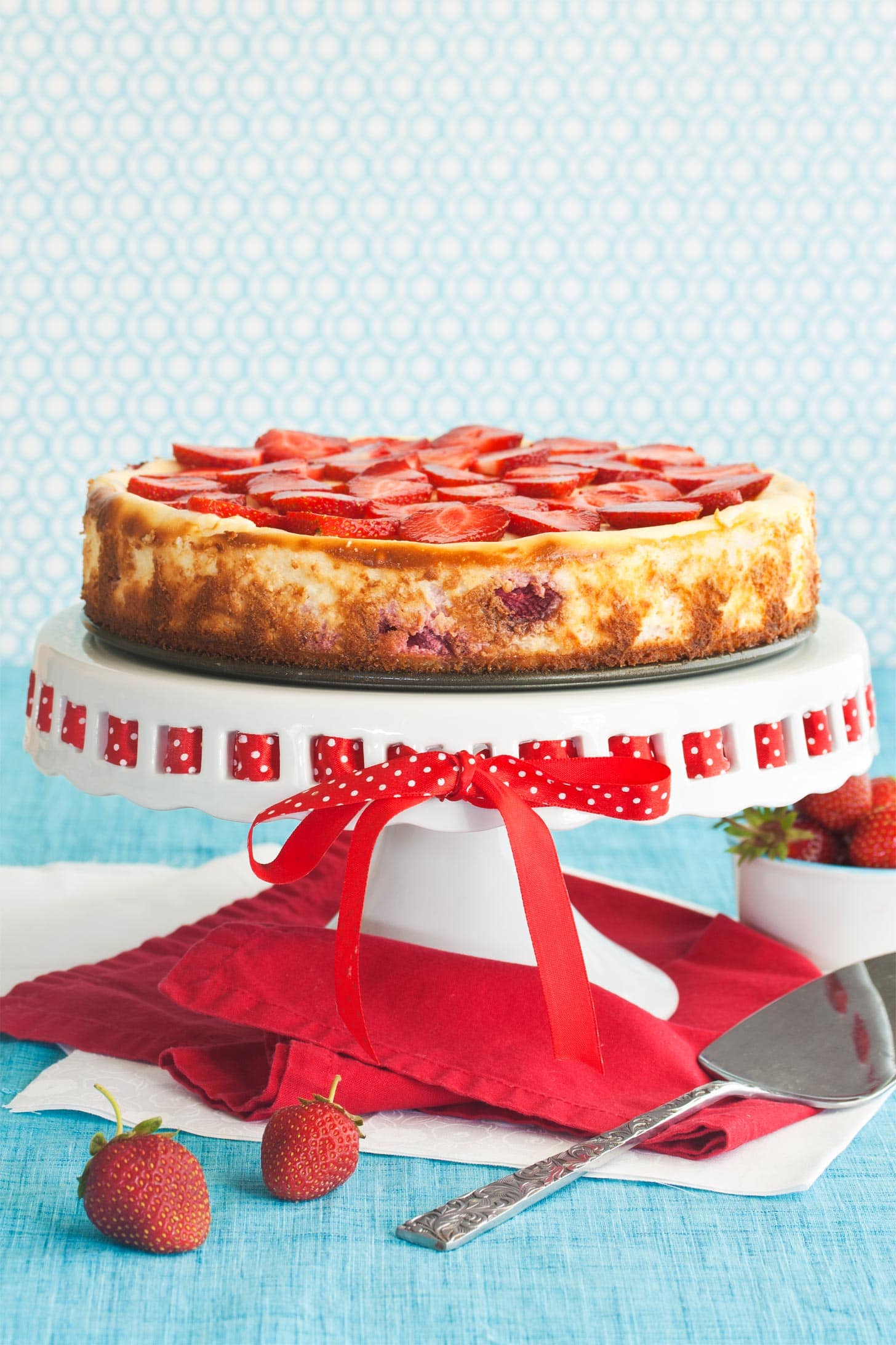 Strawberry Shortcake Cheesecake Cake on top of cake stand