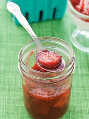 Strawberry Sauce on a spoon over a jar