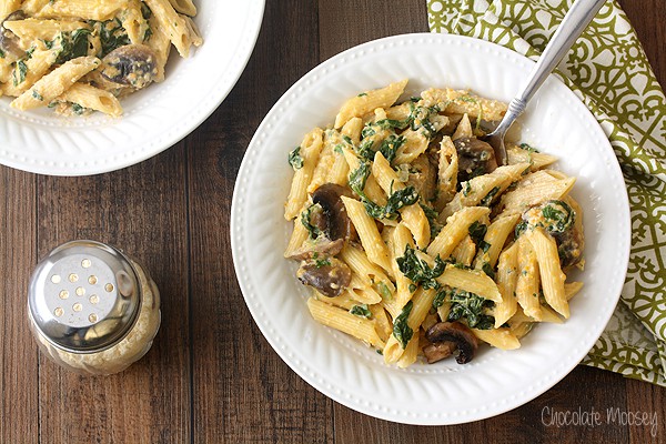 When winter squash is in season, turn it into a hearty comforting dinner for two with Butternut Squash Alfredo with pasta, spinach, and mushrooms.