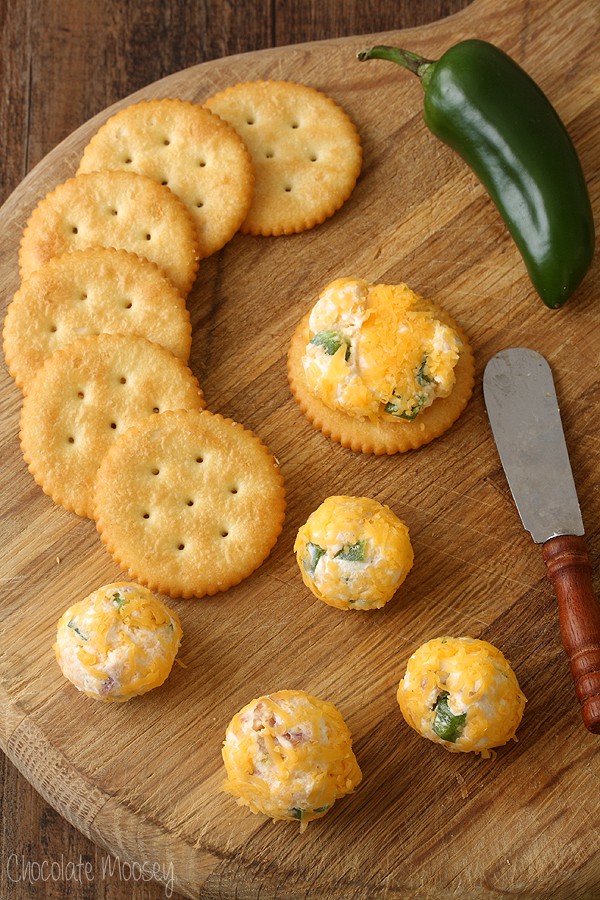 Cheese ball bites on thick wooden cutting board