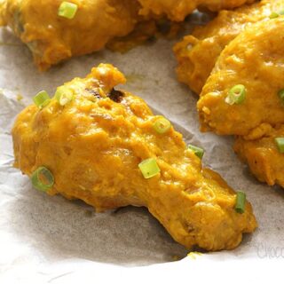 Close up of curry wing on parchment paper on cookie tray