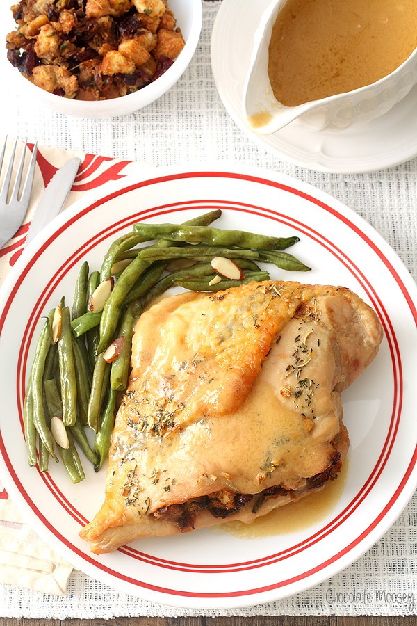 Stuffed turkey breast on plate with green beans