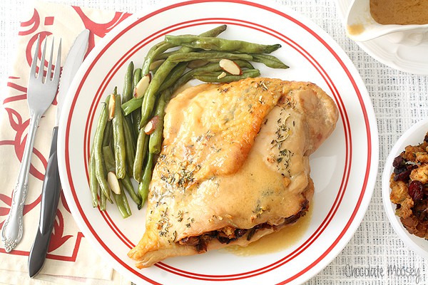 Stuffed turkey breast on plate with green beans