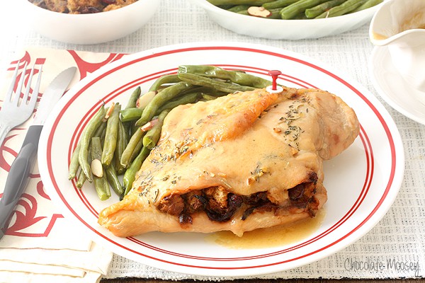 Stuffed turkey breast on plate with green beans
