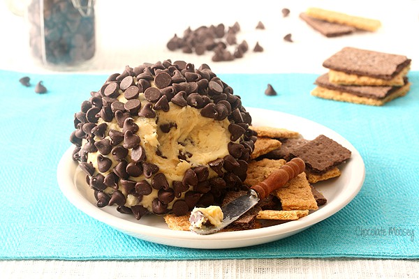 Chocolate Chip Cheese Ball on a white plate with cheese knife
